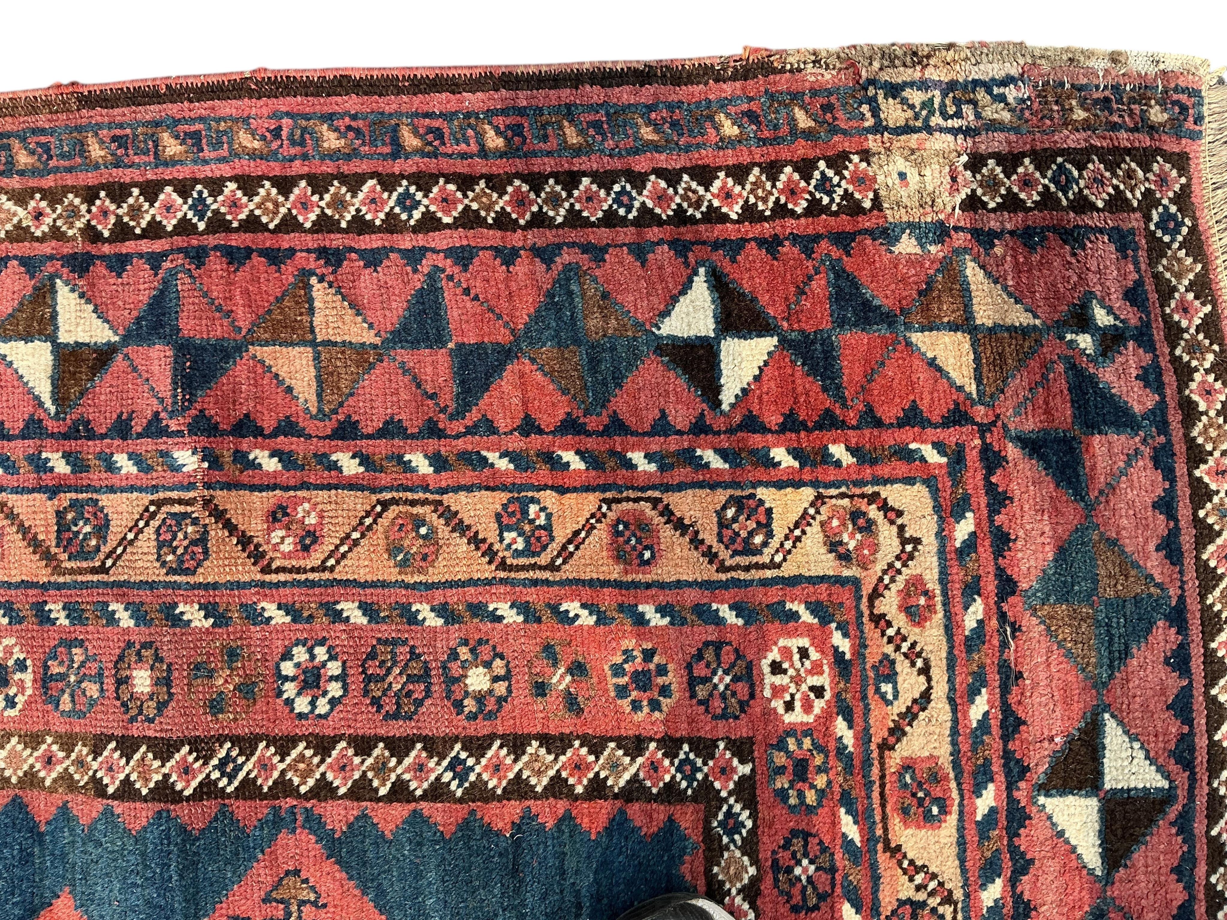 A Belouch blue ground hall carpet, 325cm x 145cm